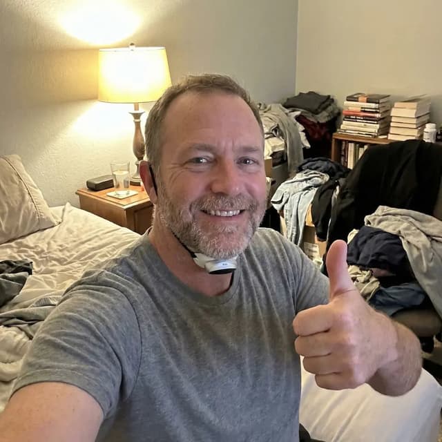 Customer giving a thumbs up while wearing the SleepEase Pro patch