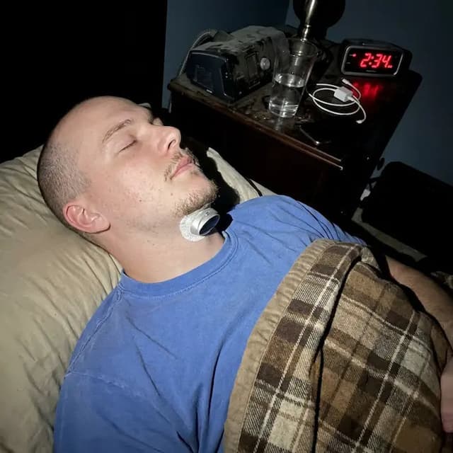 Man sleeping peacefully with SleepEase Pro, CPAP machine set aside